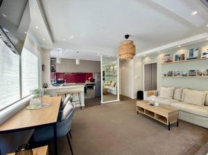 a living room with a couch and a table at Beautiful 1 bedroom unit 1 block from Coogee beach in Sydney