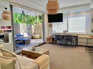 a living room with a couch and a table at Beautiful 1 bedroom unit 1 block from Coogee beach in Sydney