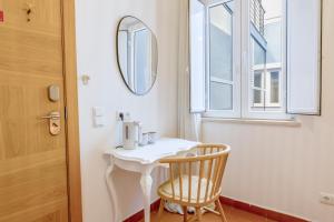 a room with a table and a chair and a mirror at Casa Luma B&B in Lagos