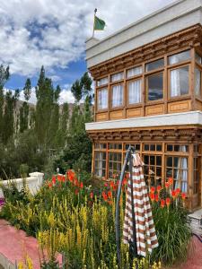 a house with a flag on top of a garden at Namra Villa in Leh