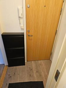 a room with a door and a wooden floor at skyline flat with free parking in Lorenskog