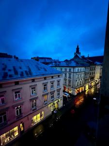 a view of a city with buildings at night at Apart-HOTEL GALLERY 21 in Lviv