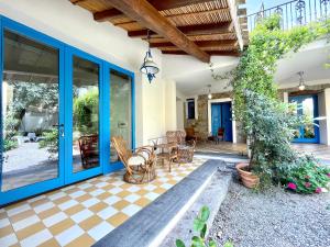 a house with a blue door and a patio at Il Carrubo with Jacuzzi & Sauna in Bari Sardo +175 photos