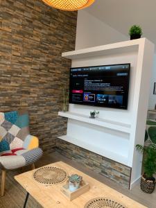 a living room with a flat screen tv on a wall at Luna y Sol in Valencia