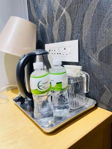 a tray with water bottles and a blender on a table at Aquarian Tide Hotel in Gaborone