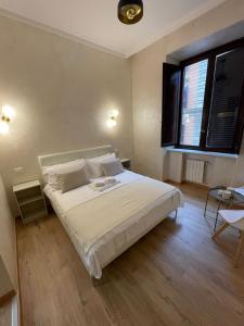 Ένα ή περισσότερα κρεβάτια σε δωμάτιο στο Ten Miles Guesthouse Roma