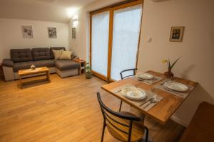a living room with a table and a couch at Vineyard Cottage Mayolka - Happy Rentals in Novo Mesto +7 photos