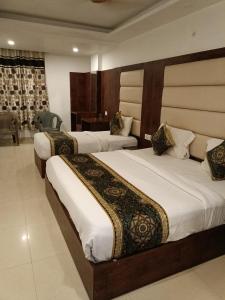 a hotel room with two beds in a room at The marine Aero Near IGI T3 Airport in New Delhi