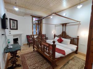 a bedroom with a canopy bed and a fireplace at Heritage Villas - Shimla British Resort, Near Mall in Shimla