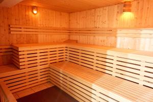 a sauna with wooden shelves and lights in it at Pension Neuerbe in Erfurt