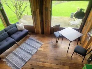 a living room with a couch and a table at The Summerhouse in Llandegla