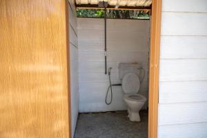 a small bathroom with a toilet in a house at Long Beach Camp in Perhentian Islands