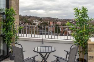 a balcony with chairs and a table and a view at Diff-Rent Living in Harrow