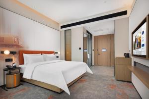 Postelja oz. postelje v sobi nastanitve Hampton by Hilton Dongguan Liaobu Songshan Lake Avenue