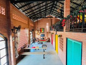 a room with a table and a hammock in a building at Ho Tram Chill House in Xuyên Mộc