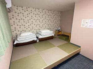 Postel nebo postele na pokoji v ubytování GuestHouse Guu