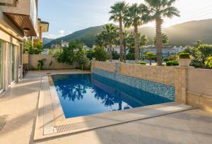 a swimming pool in the backyard of a house at Villa MO DAİLY WEEKLY rentals İçmeler in Marmaris