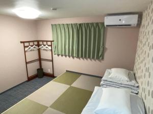 Postel nebo postele na pokoji v ubytování GuestHouse Guu