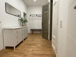 a hallway with a dresser and a mirror and a door at #attraktive Altbauwohnung im Leipziger Zentrum 1 OG links in Leipzig