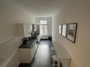 a kitchen with white cabinets and a counter top at #attraktive Altbauwohnung im Leipziger Zentrum 1 OG links in Leipzig