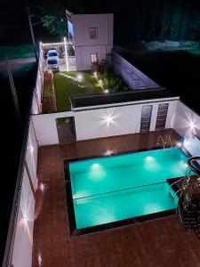 an overhead view of a swimming pool at night at Roomshala 135 Paradise Villa - Near Nandi Hills in Devanahalli-Bangalore