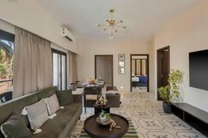 a living room with a couch and a table at Casa Felix · Luxurious 3bhk villa in Colva in Goa
