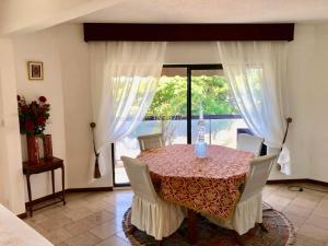 a dining room with a table and a window at Poerava Tahiti in Papeete