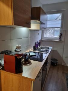 a kitchen with a stove and a counter top at Weserbergland Apartment in Bodenwerder