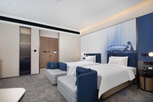 Postelja oz. postelje v sobi nastanitve Hampton by Hilton Dongguan Liaobu Songshan Lake Avenue