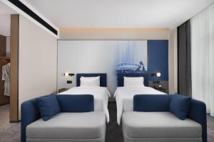 Postelja oz. postelje v sobi nastanitve Hampton by Hilton Dongguan Liaobu Songshan Lake Avenue
