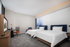 Postelja oz. postelje v sobi nastanitve Hampton by Hilton Dongguan Liaobu Songshan Lake Avenue