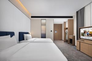 Postelja oz. postelje v sobi nastanitve Hampton by Hilton Dongguan Liaobu Songshan Lake Avenue