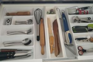 a drawer filled with utensils and other kitchen items at Viva la playa! in Empuriabrava