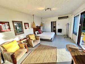 a living room with a bed and a couch at B'Lenghi Beach House in Ballito