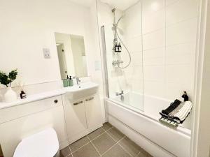 a bathroom with a shower and a toilet and a sink at Mulberry House in Stevenage