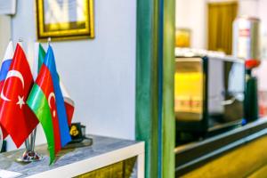 a table with flags on top of it at Old City Tower Inn in Baku