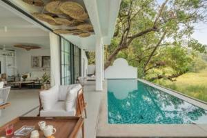 a house with a swimming pool in a living room at La Margarida · Super luxury 5BHK villa in Anjuna in Goa