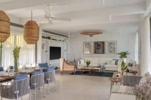a large living room with a table and chairs at La Margarida · Super luxury 5BHK villa in Anjuna in Goa