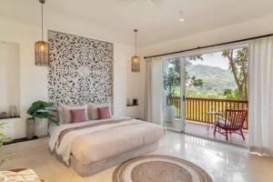 a bedroom with a large bed and a balcony at La Margarida · Super luxury 5BHK villa in Anjuna in Goa +89 photos