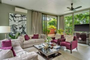 a living room with purple furniture and a tv at sohonos · Luxurious 3bhk villa in Candolim in Goa