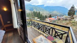 a balcony with a view of a mountain at Wonder Hill Inn in Lachung