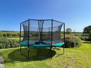 a trampoline in the grass in a field at Montgomery Barn in Bideford