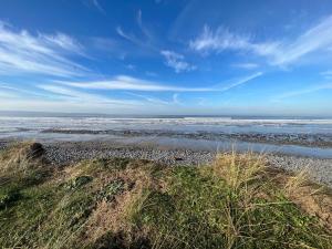 a view of the ocean from a sandy beach at Montgomery Barn in Bideford