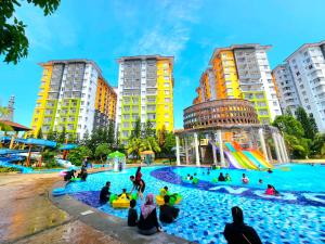 a group of people playing in a water park at BY LG Water Themepark Facilities & Suites By GGM in Melaka