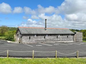 a building with a parking lot in front of it at Montgomery Barn in Bideford