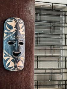 a mask on the side of a building at Full Moon Hostel - Beer Pong Central in Coron