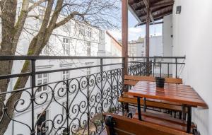 a balcony with a wooden table and two benches at Starowiślna 36 Apartment with Mezzanine in Krakow