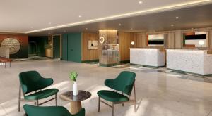 a lobby with green chairs and a table at Manchester Marriott Hotel Piccadilly in Manchester