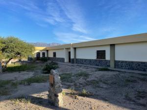 a building in the middle of a desert at Casa de Retiros Virgen de Guadalupe, Finca la Soledad. Bodega Prelatura in Santa María