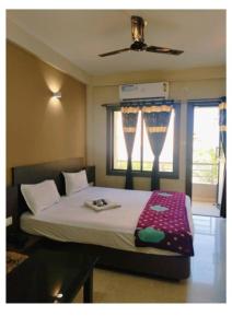 a bedroom with a large bed with a window at Hotel UK Palace Puri Near Sea Beach Best Seller in Puri